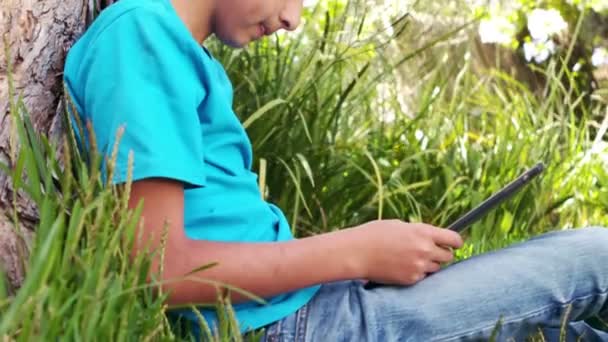 Симпатичный мальчик слушает музыку в наушниках — стоковое видео