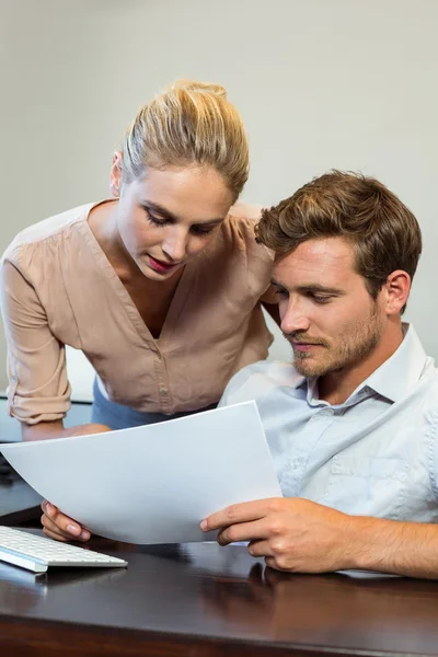 Happy colleagues holding documents — Stock Photo, Image