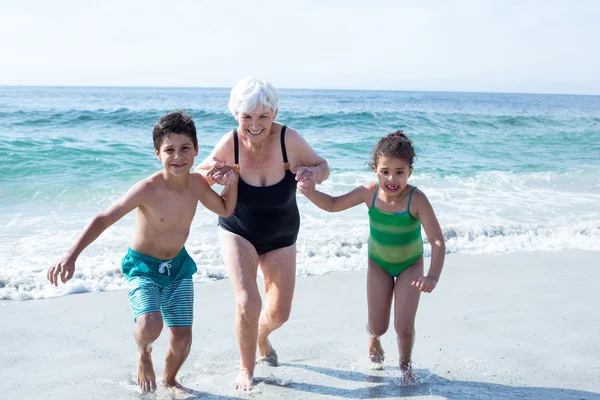 Grandmother with grandchildren running — Stock Photo, Image