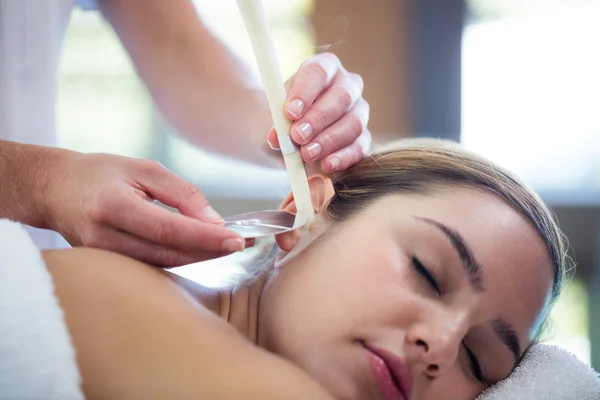 Woman receiving ear candle treatment — Stock Photo, Image