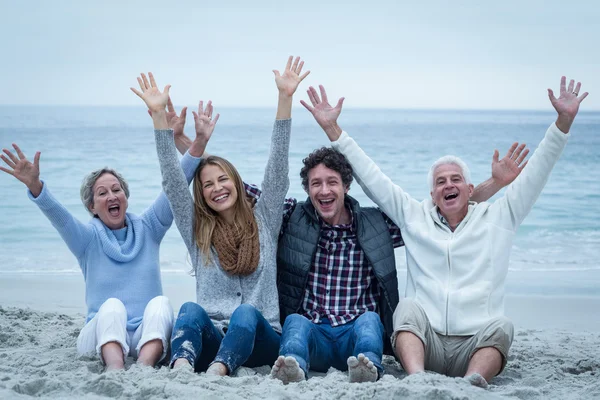 Family with arms raised sitting — Stock Photo, Image