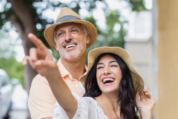 Woman pointing away while man looking — Stock Photo, Image