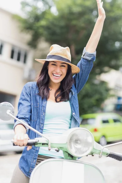 Woman riding with raised arm — Stock Photo, Image