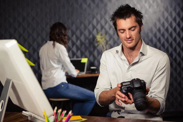 Creative businessman looking at picture — Stock Photo, Image