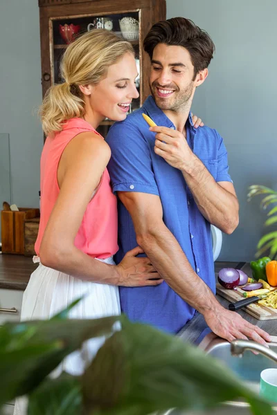 Homem alimentando sua mulher na cozinha — Fotografia de Stock