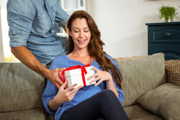 Man giving surprise gift to woman — Stock Photo, Image