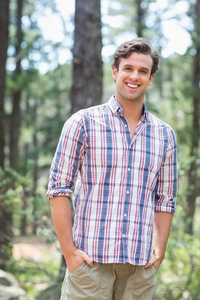 Handsome man standing in forest — Stock Photo, Image