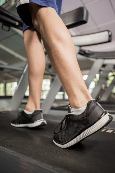 Man's feet while walking on thread mill — Stock Photo, Image