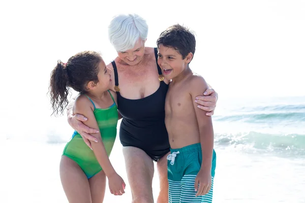 Happy children with grandmother standing — Stock Photo, Image