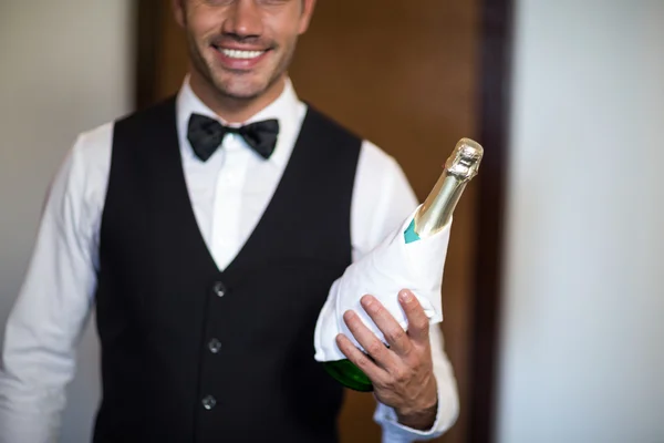 Handsome barman serving champagne — Stock Photo, Image