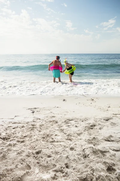 Äldre par njuter på stranden — Stockfoto