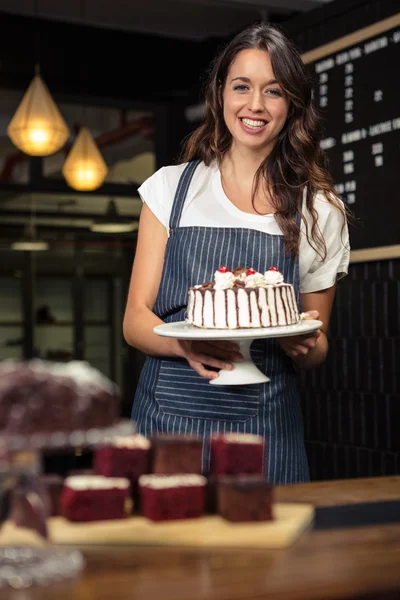 Barista holding plate with cake — Stock Photo, Image