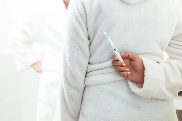 Woman hiding pregnancy test from man — Stock Photo, Image