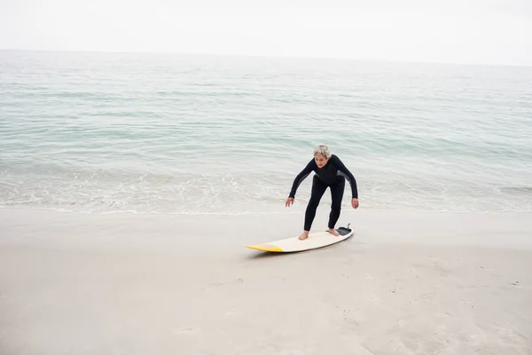 Mulher sênior surfando na prancha — Fotografia de Stock