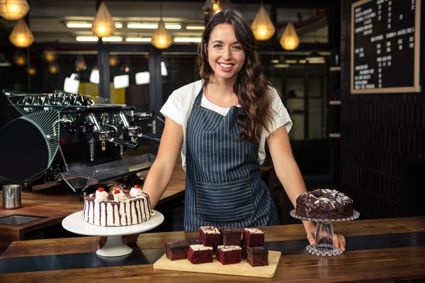 Barista presenting plate with cakes — Stock Photo, Image