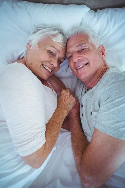 Couple holding hands while lying — Stock Photo, Image