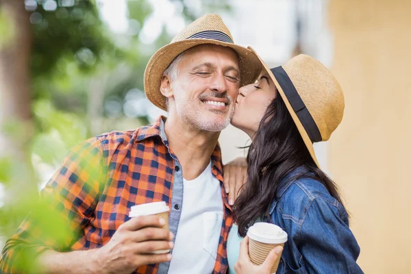 Woman kissing on man's cheek — Stock Photo, Image