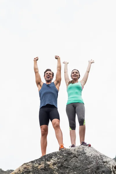 Cheerful young couple on rock — Stock Photo, Image