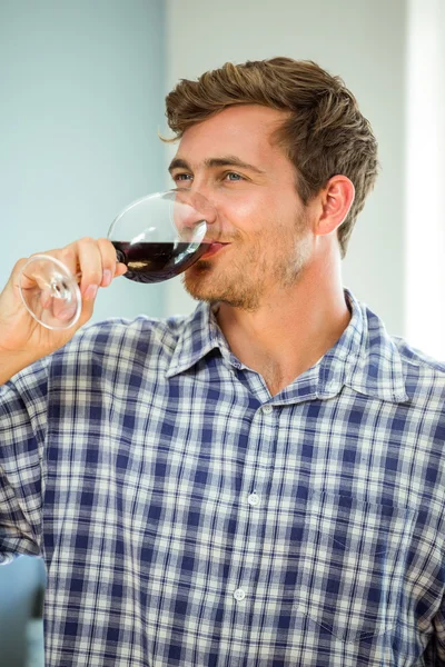 Young man having red wine — Stock Photo, Image