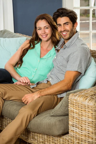 Couple sitting together in sofa — Stock Photo, Image