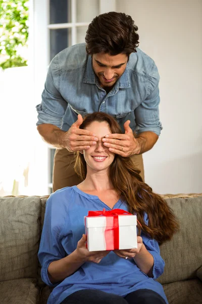 Man giving surprise gift to woman