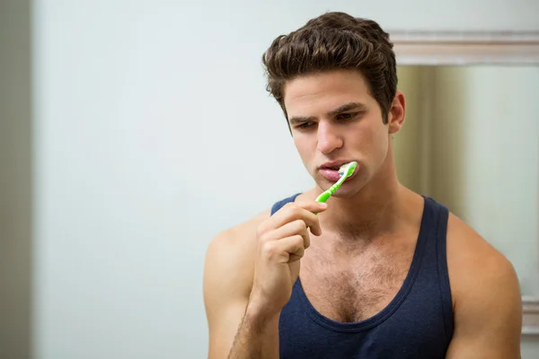 Homme brossant ses dents dans la salle de bain — Photo