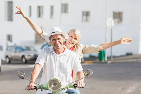 Happy couple riding motor scooter — Stock Photo, Image