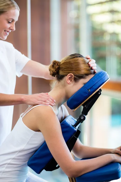 Woman receiving massage in massage chair — Stock Photo, Image