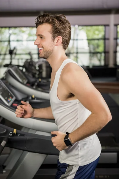 Man running on thread mill — Stock Photo, Image