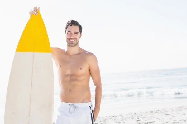 Hombre sosteniendo tabla de surf en la playa — Foto de Stock