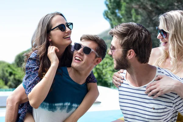 Two men giving a piggy back to women — Stock Photo, Image