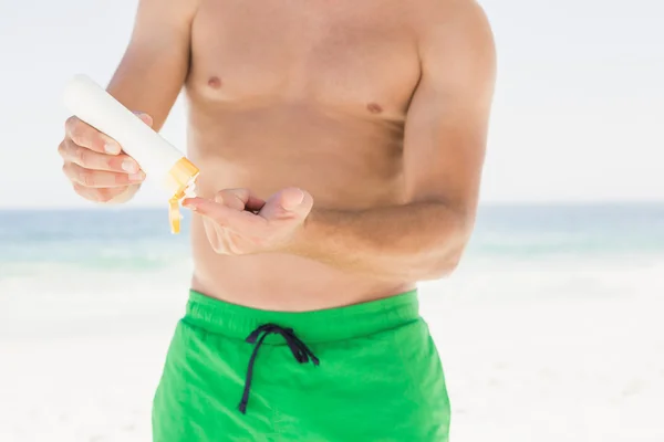Portrait of man applying sun cream — Stock Photo, Image