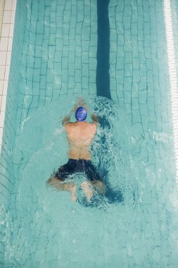 Swimmer doing breaststroke in swimming pool clipart