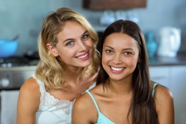 Female friends smiling at home — Stock Photo, Image