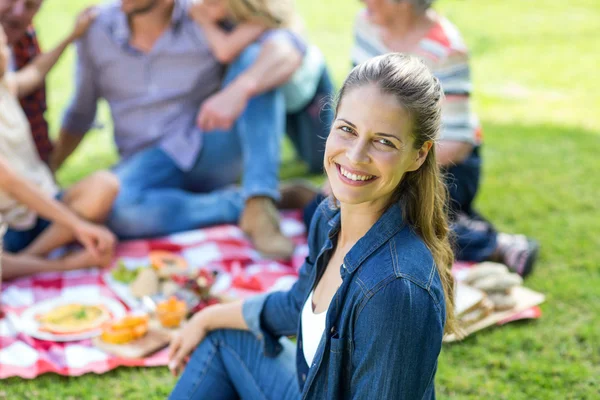 Young woman sitting with family — Stock Photo, Image