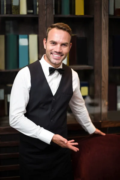 Handsome waiter welcoming client — Stock Photo, Image