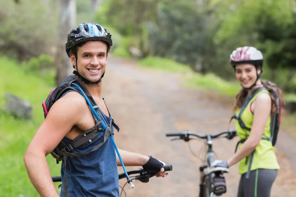 Confident biker with woman — Stock Photo, Image