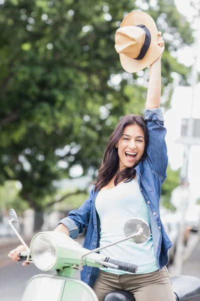 Cheerful woman holding hat — Stock Photo, Image