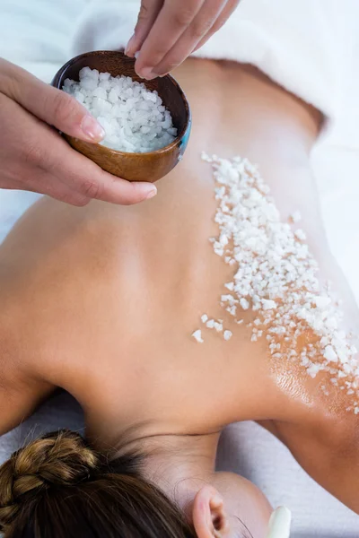 Woman enjoying salt scrub massage — Stock Photo, Image
