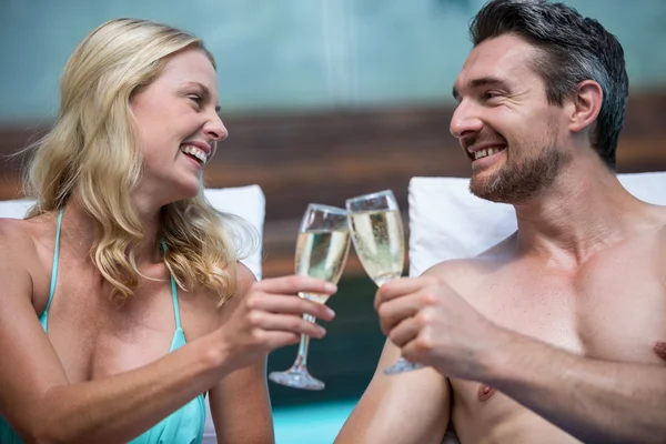 Paar sitzt und prostet Champagner zu — Stockfoto