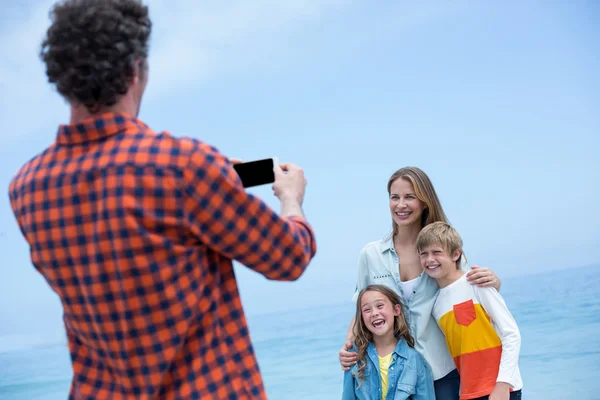 Father photographing cheerful family — Stock Photo, Image