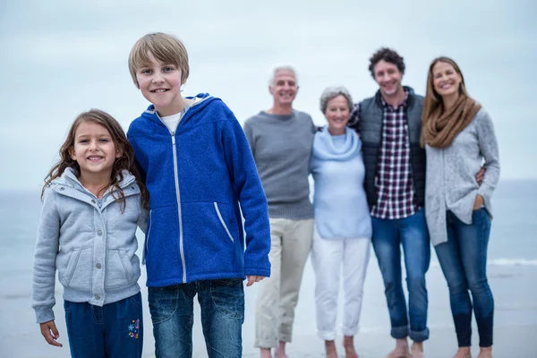 Siblings while family in background — Stock Photo, Image