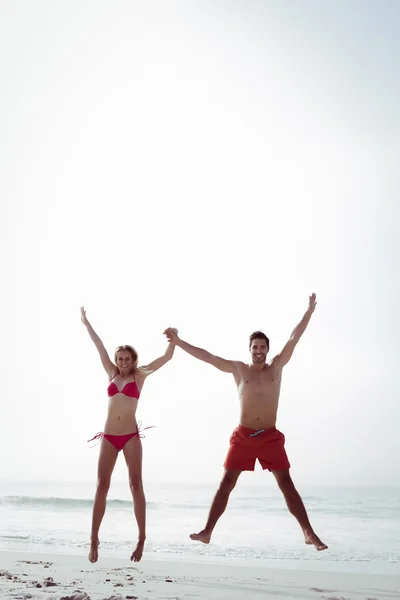 Pareja feliz saltando juntos — Foto de Stock