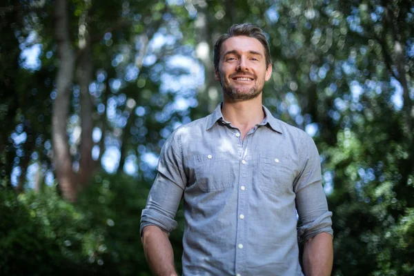 Young man against trees — Stock Photo, Image