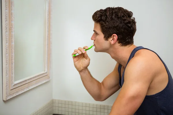 Homme brossant les dents dans la salle de bain — Photo