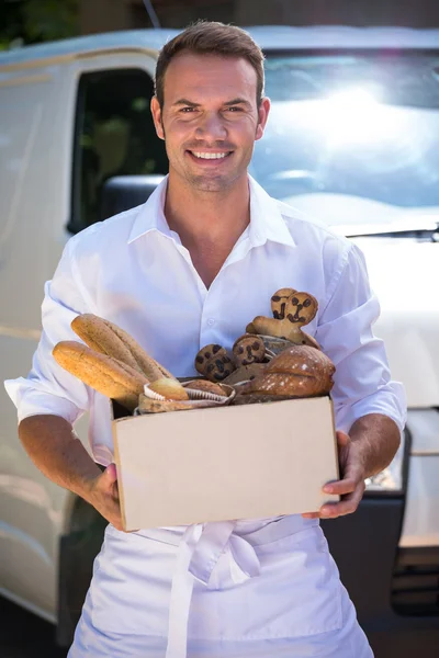 Delivery man standing in front of his van — Stock Photo, Image