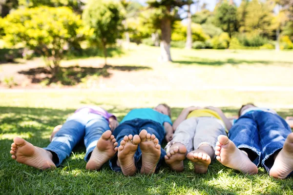 Children lying on grass — Stock Photo, Image