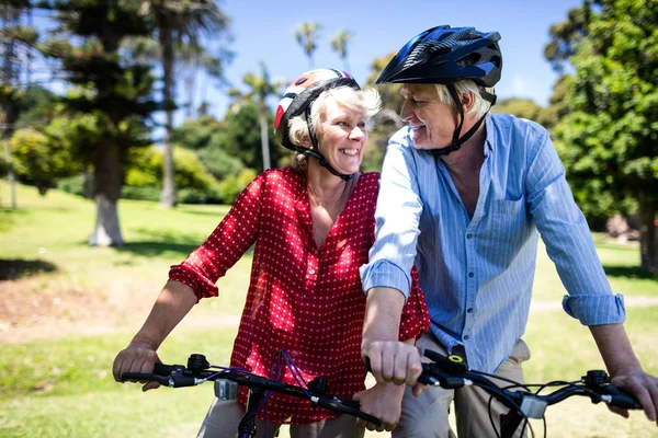 Couple riding bicycles in park — Stock Photo, Image