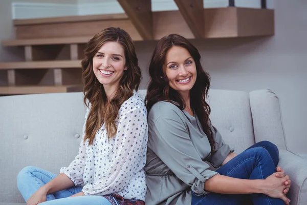 Vrouwen zitten rug aan rug op Bank — Stockfoto