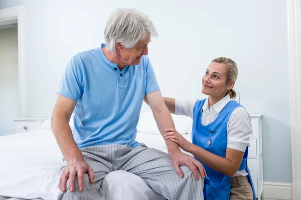Nurse comforting senior man at hospital — Stock Photo, Image